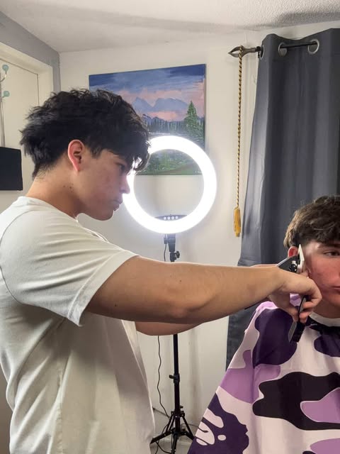 Senior Michael Grijalva Godoy seen cutting hair of customer.
Courtesy of Michael Grijalva Godoy