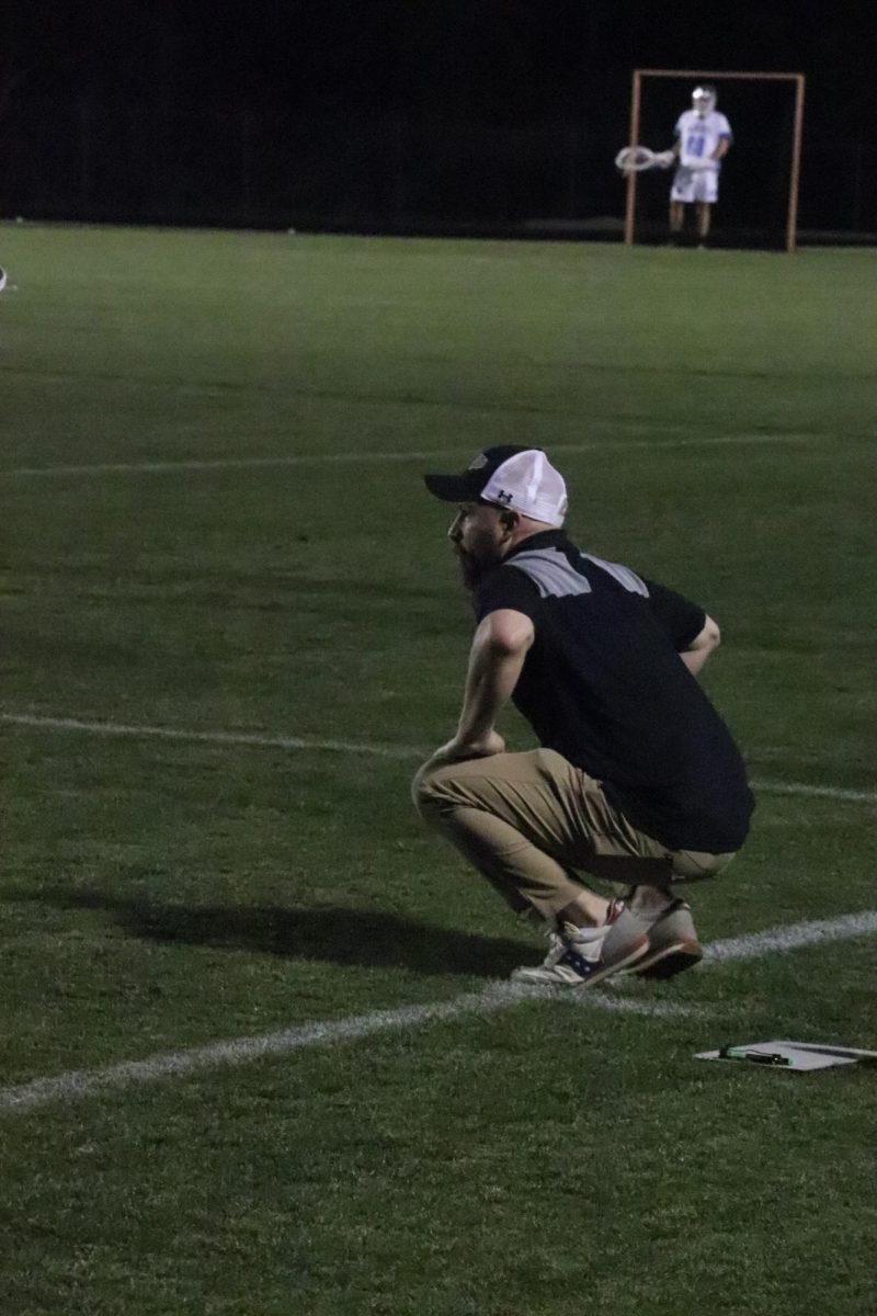 Boys Lacrosse coach Dominic Koplar watches intently as a play unfolds.