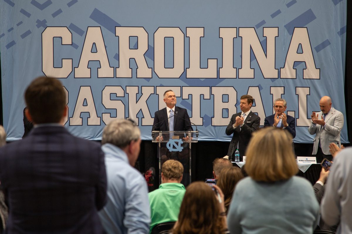 UNC basketball head coach Michael Malone stands at the lectern during his introductory press conference in the Dean E. Smith Center on Tuesday, April. 8, 2026.