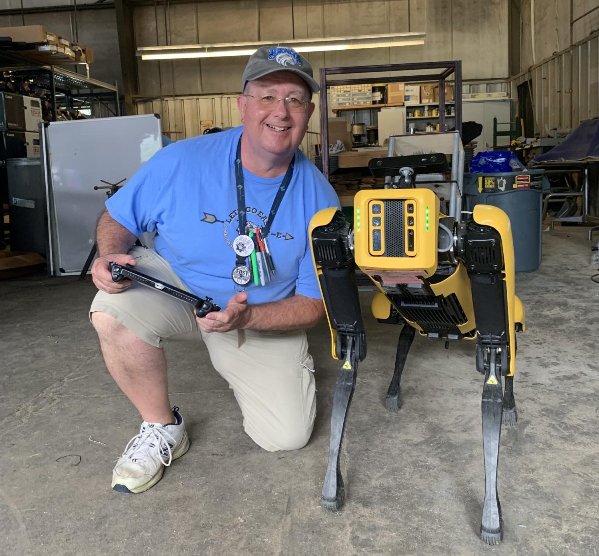 Bill Vincent posing with a robot dog